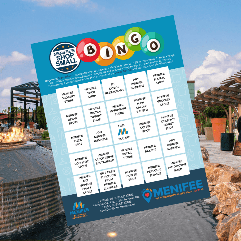 A bingo card titled "Shop Small" showcases local businesses in Menifee, set against the backdrop of an inviting outdoor fire pit and seating area on a sunny day. I'm sorry, but there doesn't seem to be any additional content needed for SEO keywords.